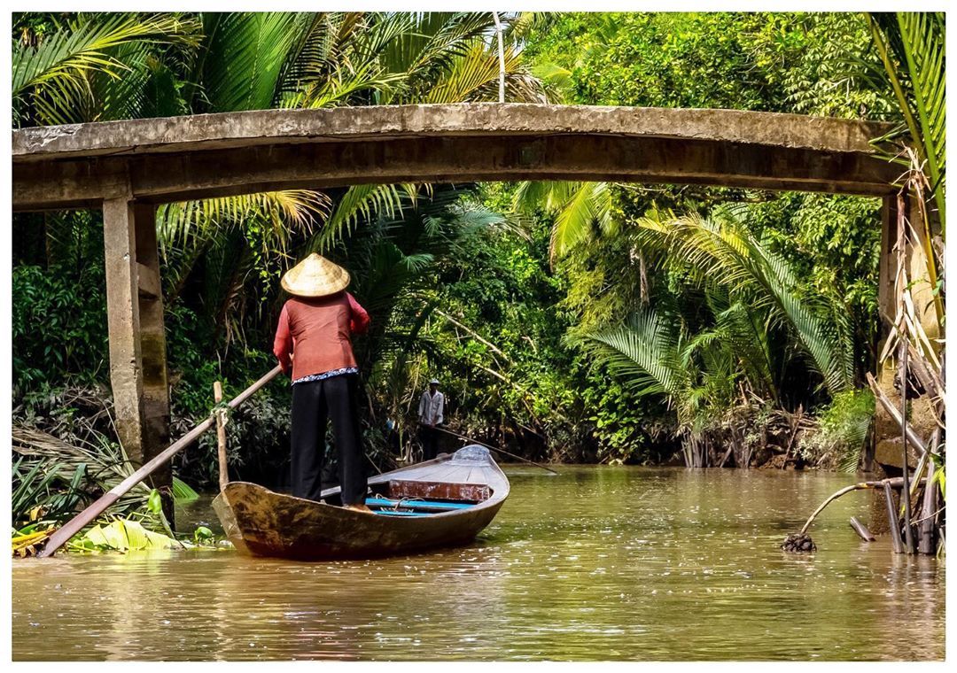 Vietnamese woman on a boat on Mekong, Vietnam